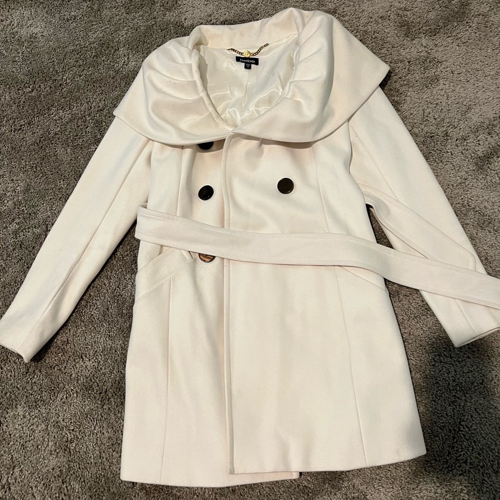Beautiful cream colored BEBE dress coat. Kept in a smoke free home no stains.